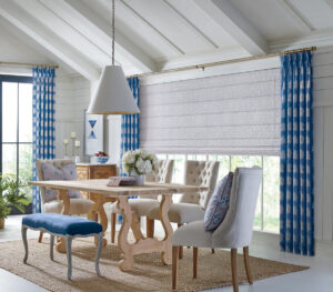 Roman shades and drapes on a large picture window in a dining room